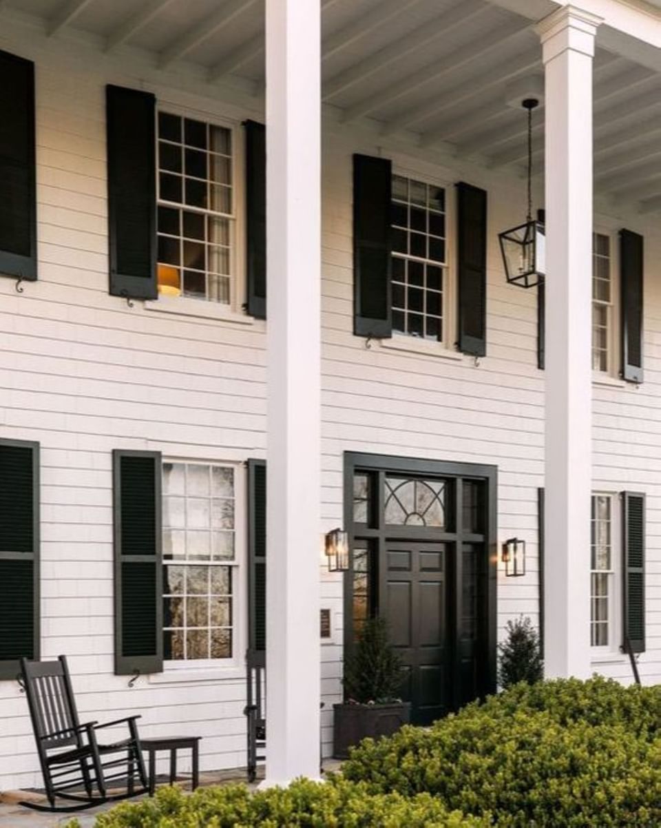 Exterior view of the front veranda with rocking chairs at The Clifton