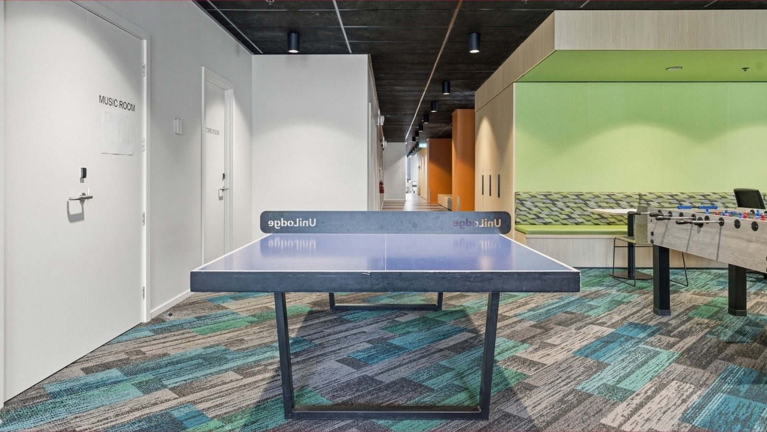 Ping pong table in a colorful lounge area at Mayoral Drive Student Accommodation.