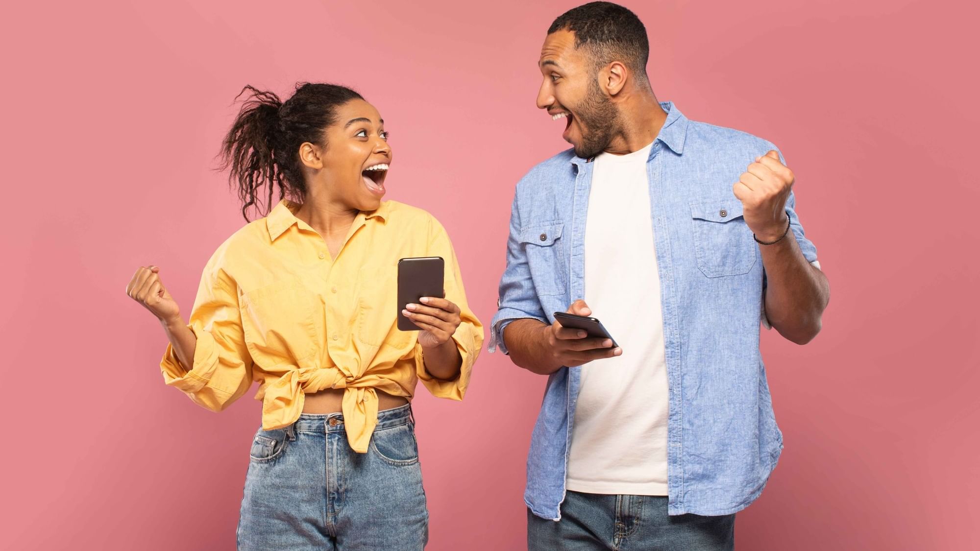 Man & woman cheering with their phones in hand at Cove Pocono Resorts