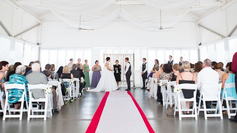 Wedded couple exchanging vows at Plantation Deck in Mercure Hotel Townsville