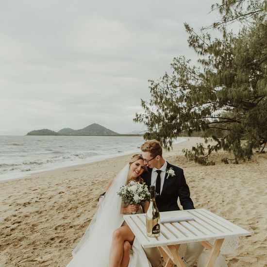 Wedding couple by the sea at Pullman Palm Cove Sea Resort