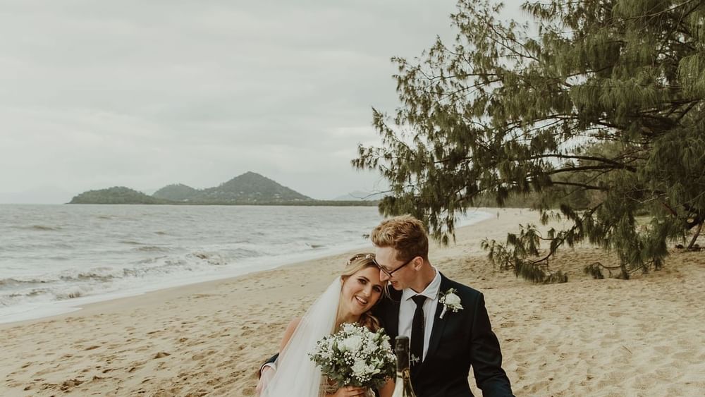 Wedding couple by the sea at Pullman Palm Cove Sea Resort