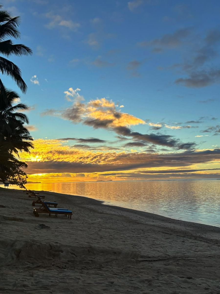 Beach sunset with lounge chairs at Warwick Fiji Resort and Spa in Korolevu.