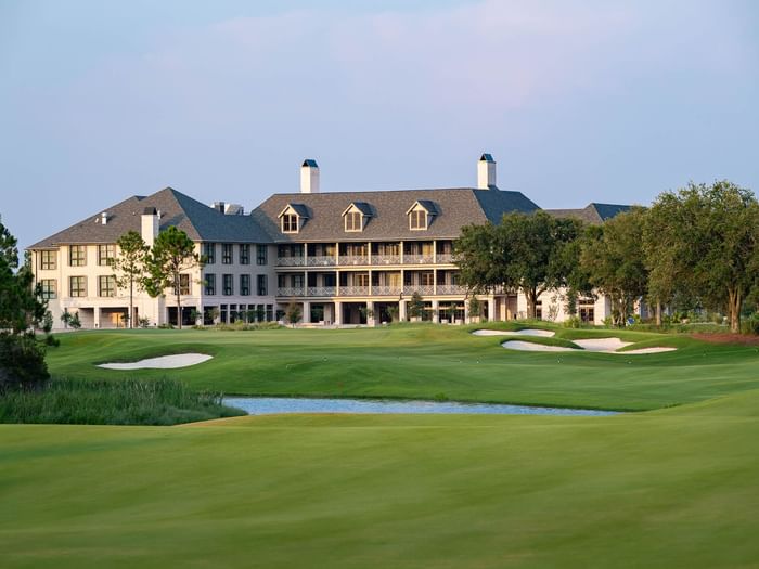 Aerial view of the hotel with lush greenery and golf course nearby at Camp Creek Inn