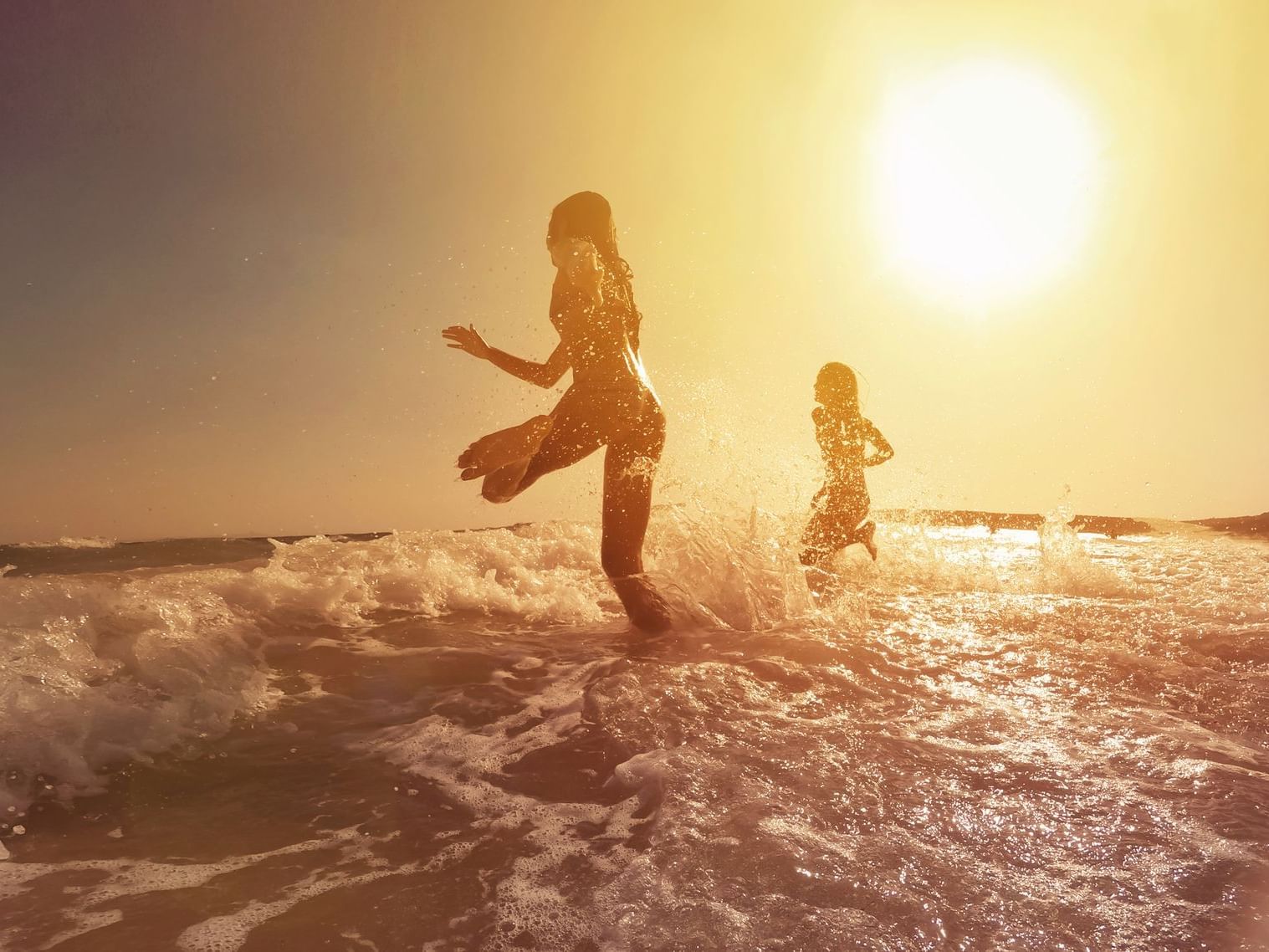 Two girls running towards the ocean near at The Rockaway Hotel