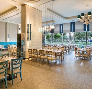 Dining area with table setting in Parkfora Main Restaurant at Titanic Deluxe Lara