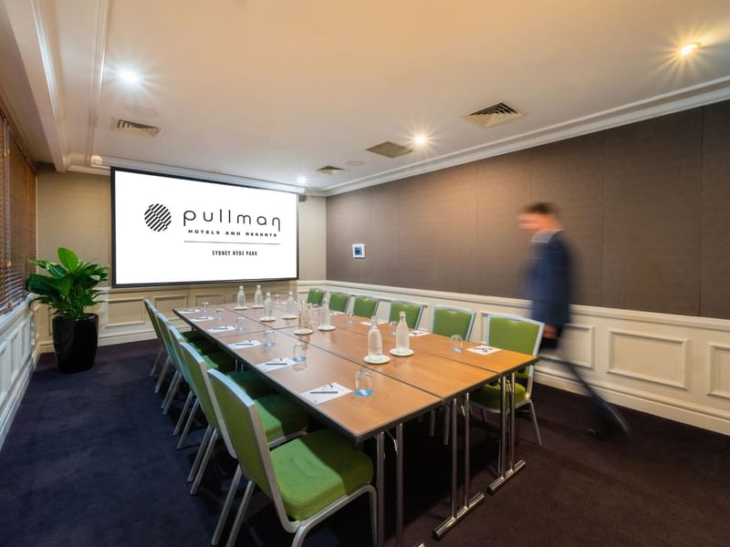 Boardroom set-up with projector screen in Dalley Room at Pullman Sydney Hyde Park