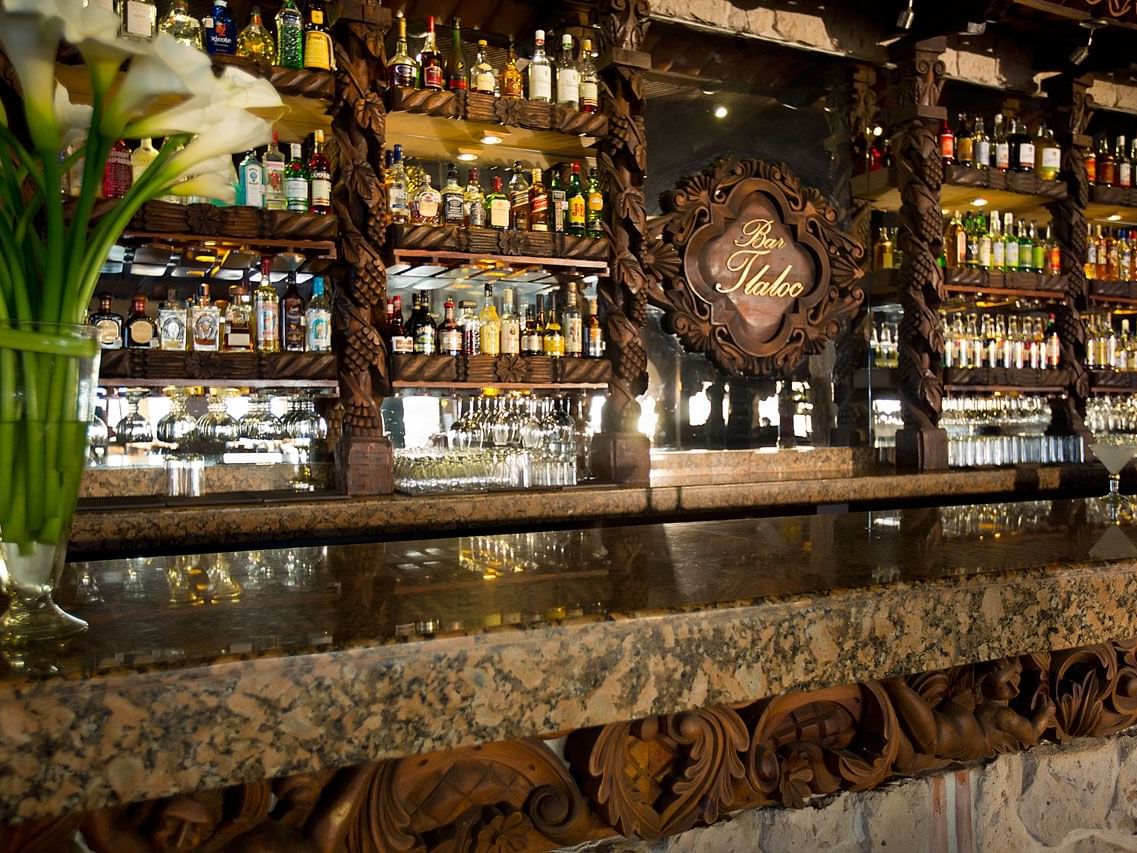 Liquor bottles by the counter in Bar Tlaloc at Casa Dona Susana