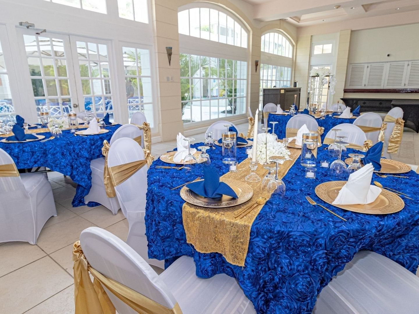 Elegantly set dining tables with blue and gold decor at Savannah Beach Hotel.