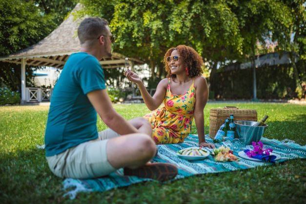 A couple sitting on the mat outdoors at Jamaica Pegasus Hotel