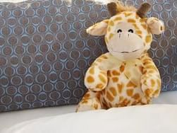 Soft toy on a bed in a room at Rheinland Hotel Kollektion