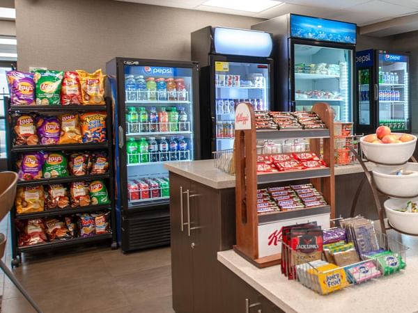 Hotel sundries shop with assorted snacks and beverages.