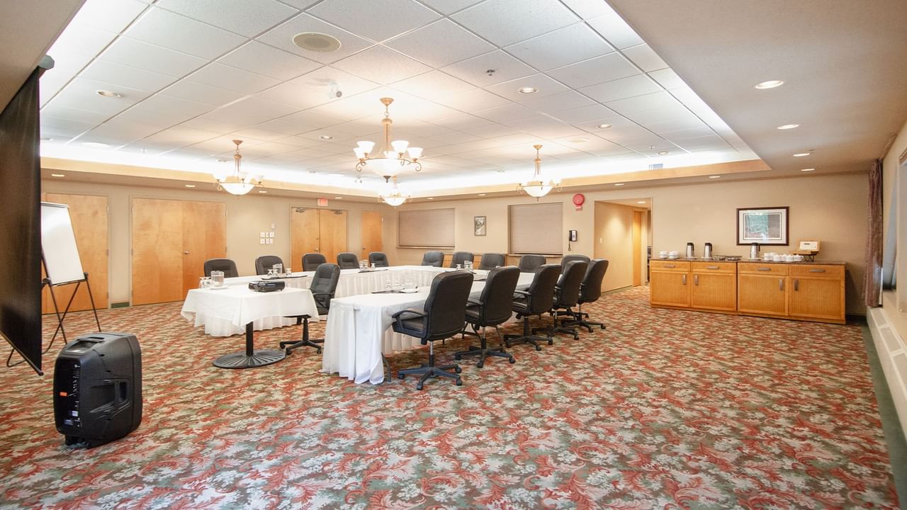 Meeting room with tables, chairs, and projector