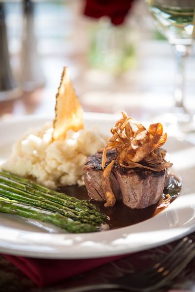 Meat entree with mashed potatoes and asparagus