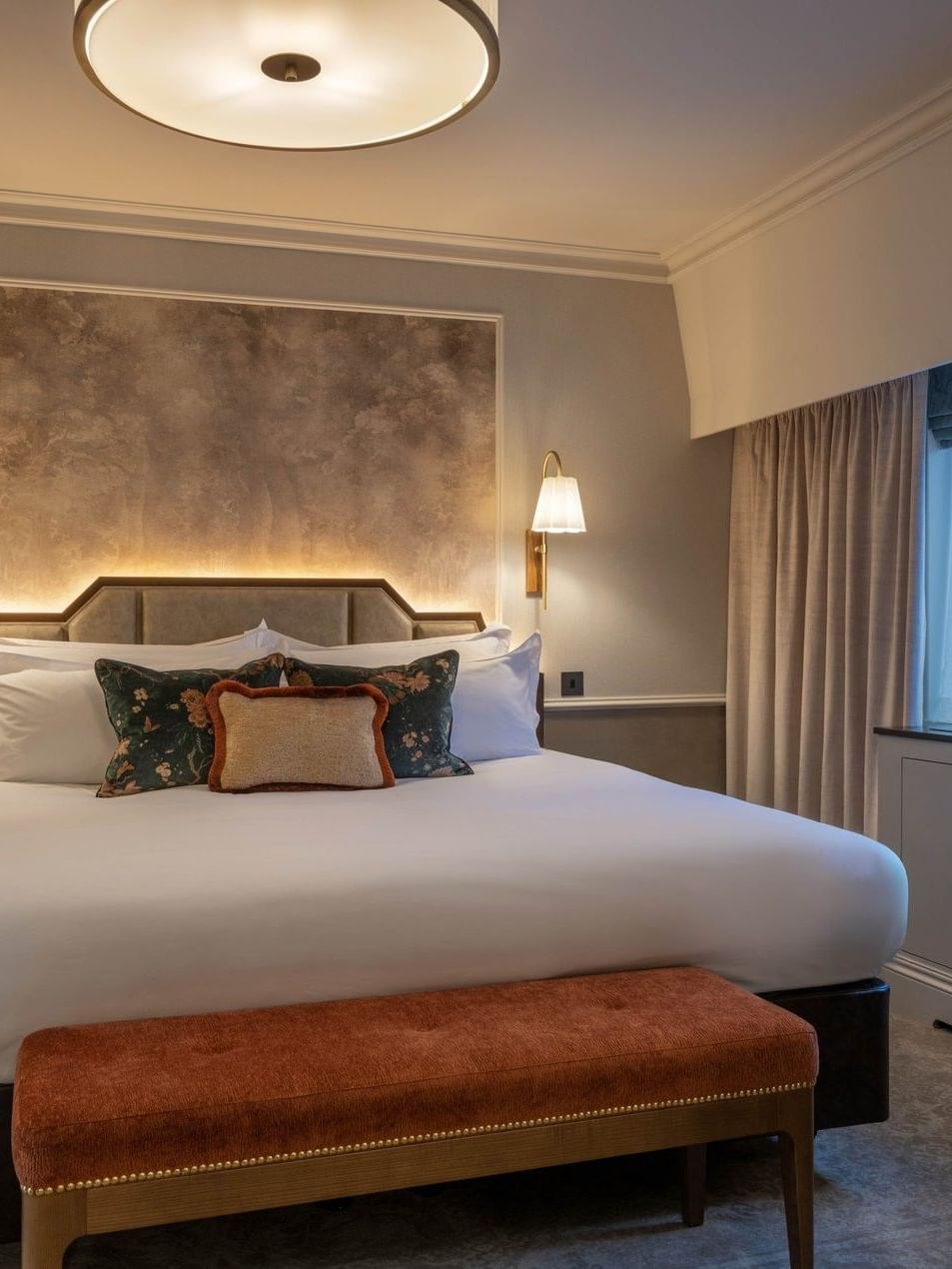 Bed with ottoman near window in Townhouse Junior Suite at The Capital Hotel, Apartments and Townhouse