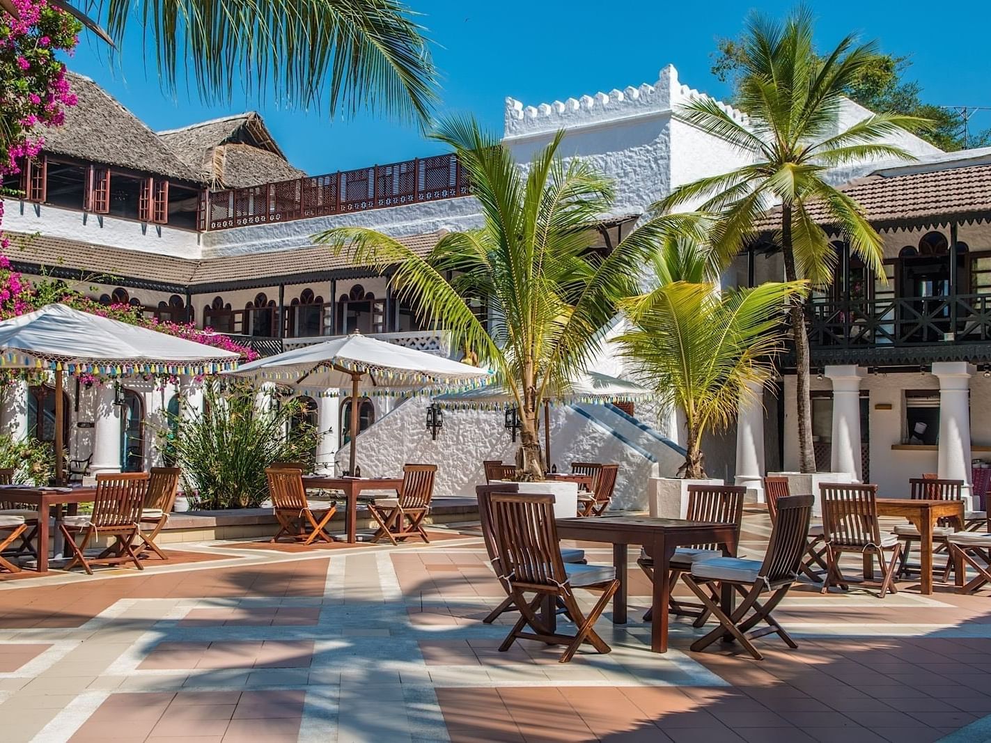 Outdoor dining area with tables and chairs at Sokoni restaurant, Serena Beach Resort & Spa in Mombasa.
