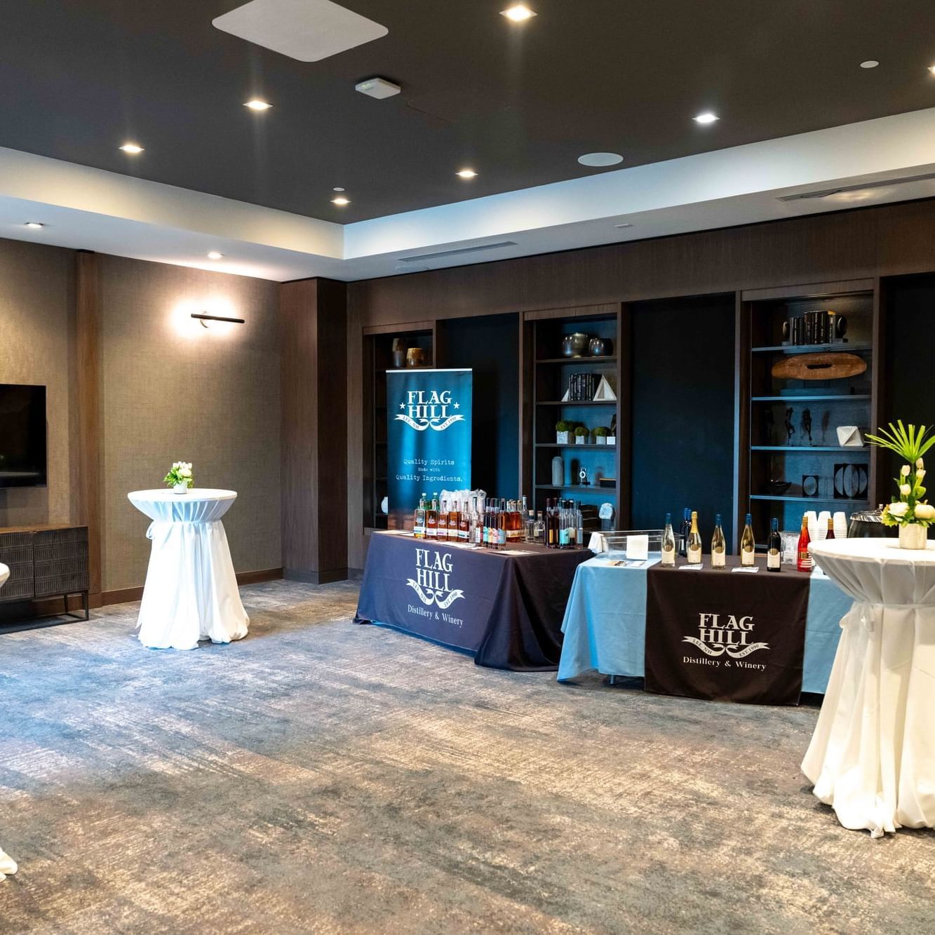Tables & wine racks in an event room lounge area at The Artisan Hotel at Tuscan Village