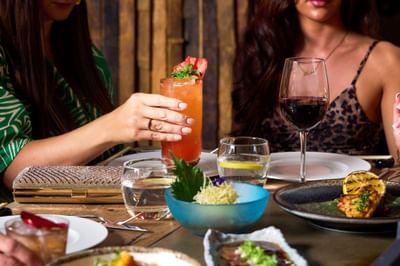 Two women dining surrounded by a selection of food from the set menu and drinks at Peter Street Kitchen
