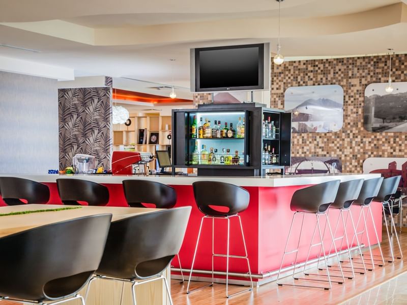 Lobby bar area with bar stools at Fiesta Inn Hotels
