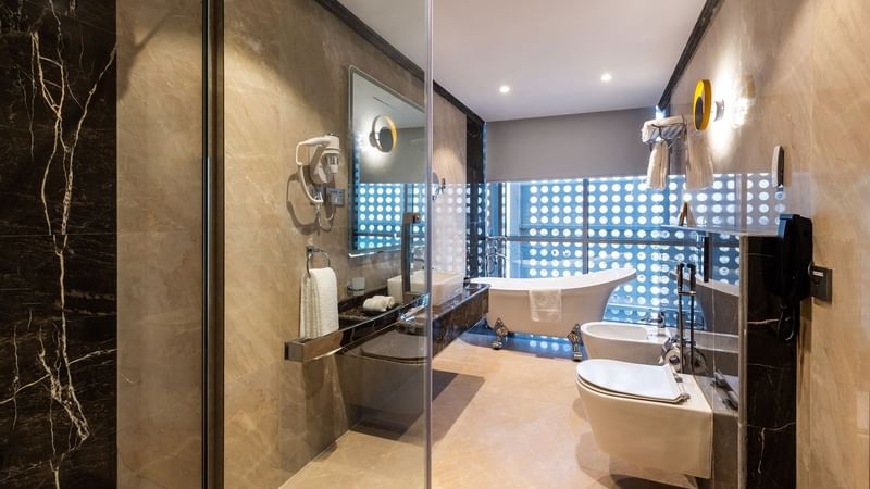 Wash basin, bathtub with lavatory in Executive Suite bathroom at Warwick Riyadh