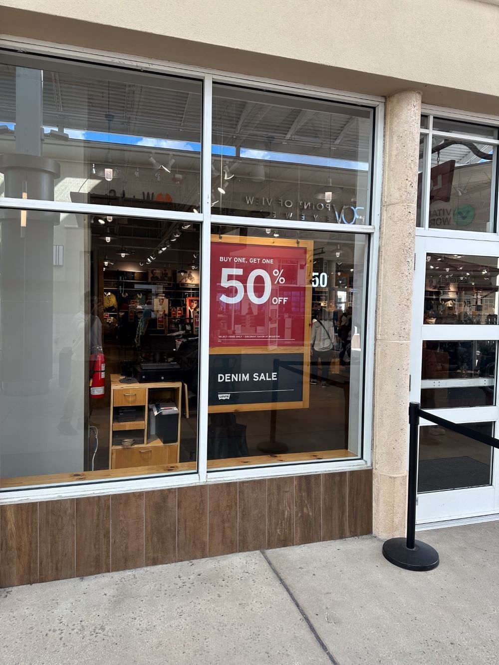 A "Buy One Get One 50%" displayed in the window of a Levi's store at an Orlando outlet mall.