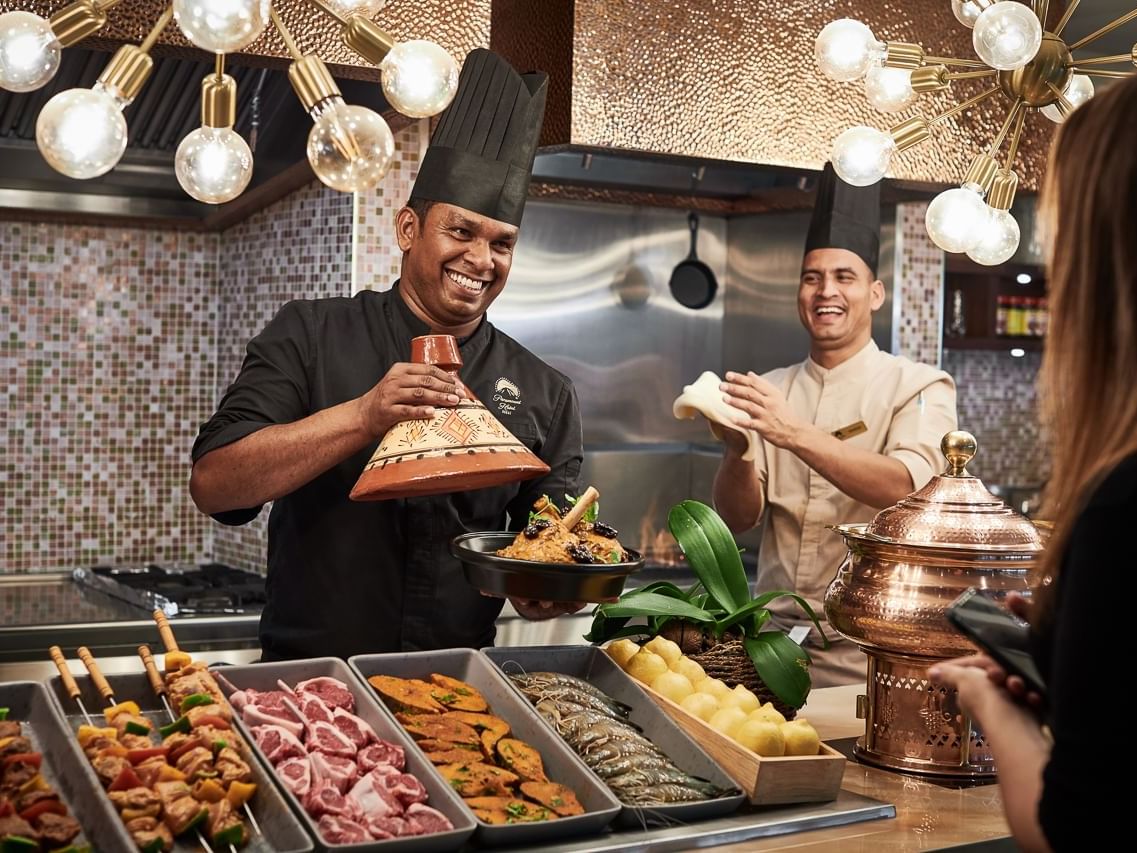 Happy chefs presenting dishes in The Stage Restaurant at Paramount Hotel Dubai