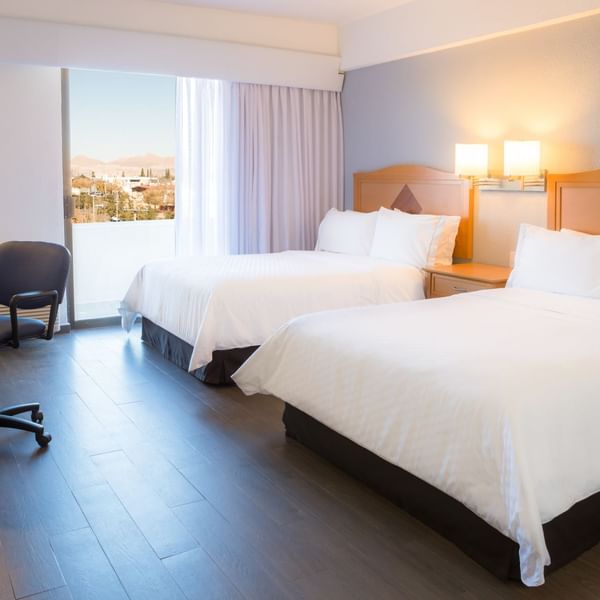 Twin beds with working desk in Superior Room at Fiesta Inn