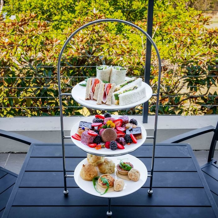 Three-tiered High Tea stand with pastries, and sandwiches at Mercure Kooindah Waters