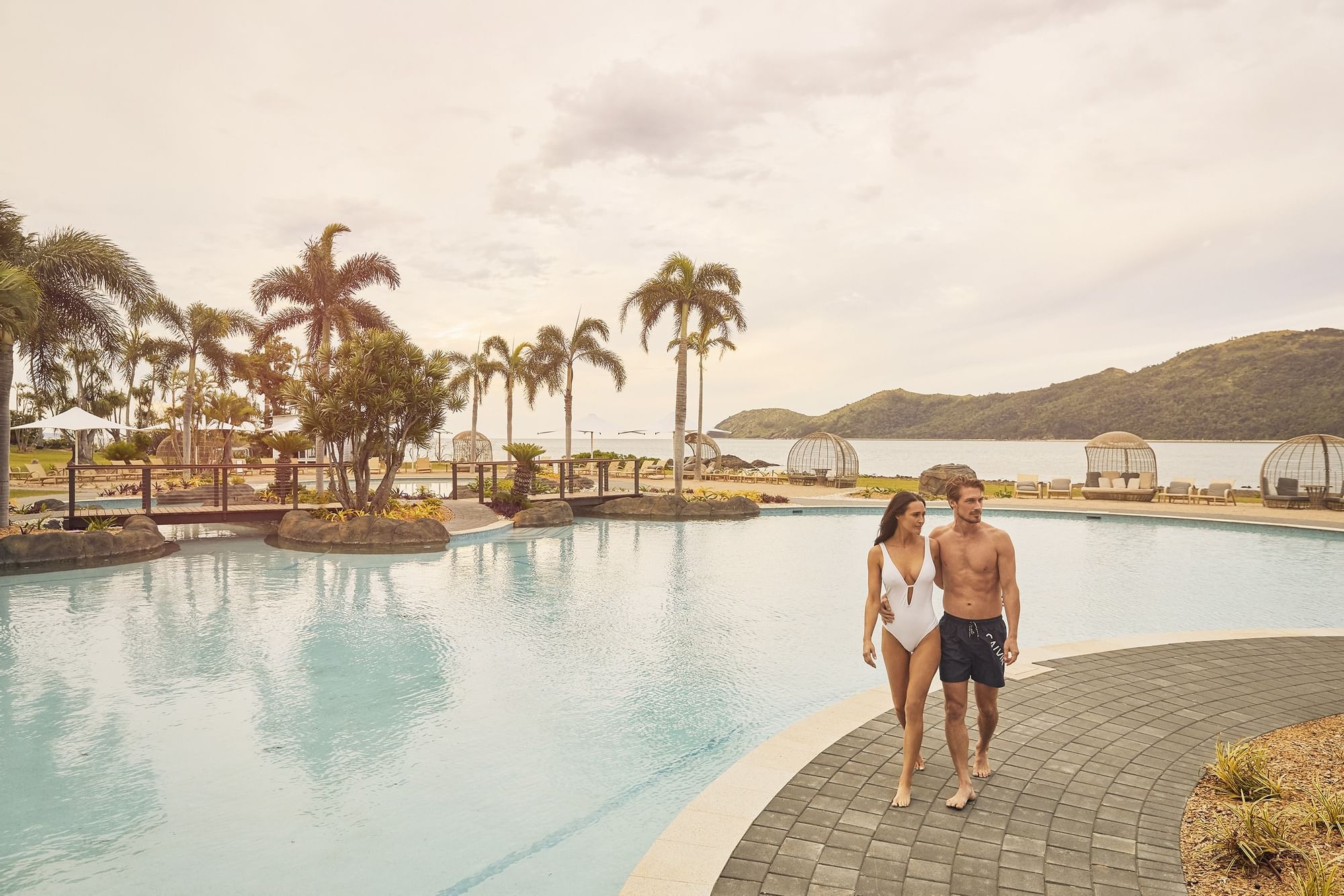 Couple posing by the pool deck at Daydream Island Resort