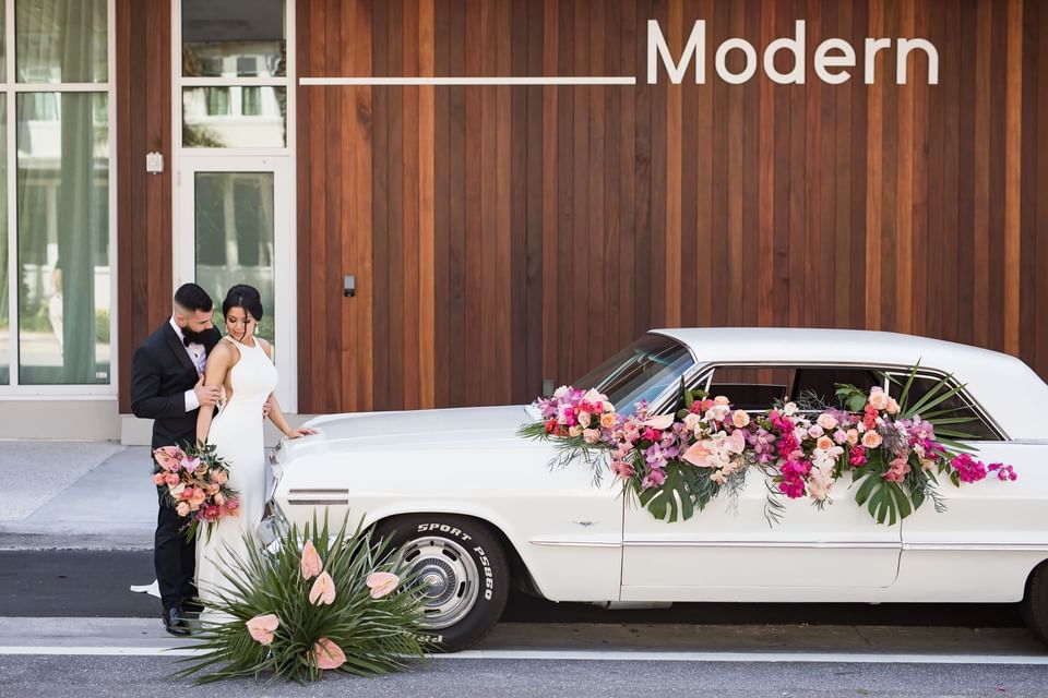 Wedded couple & car by the entrance at The Sarasota Modern 