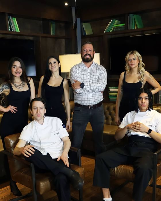 the shark club team posing at shark club looking happy and daper