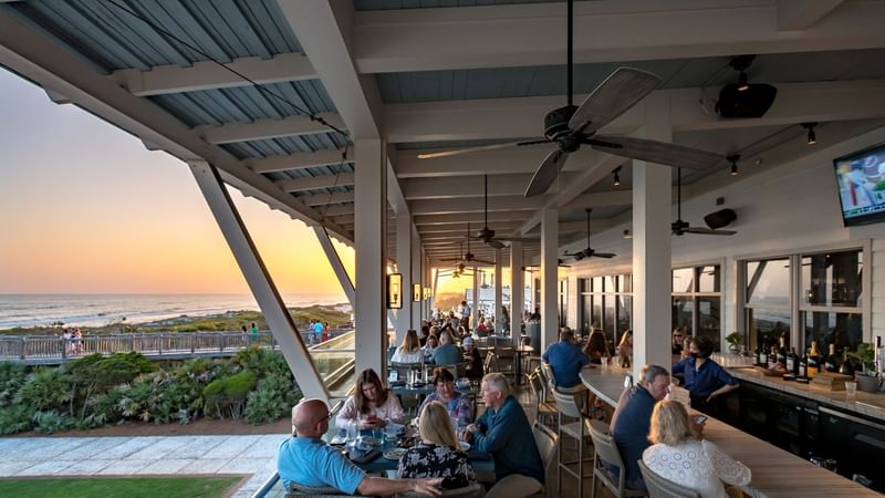People dining in Open-air rooftop dining area at WaterColor Inn