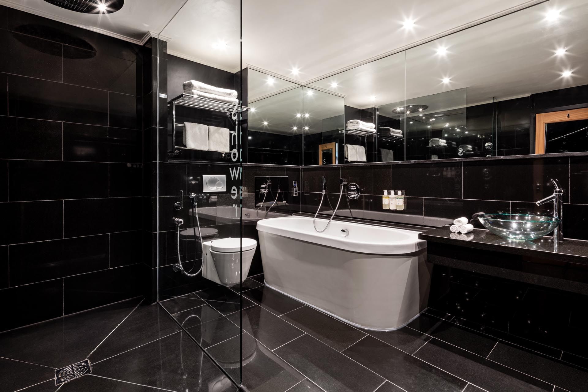 Saffron Suite bathroom with a freestanding tub and walk-in shower at The May Fair Hotel