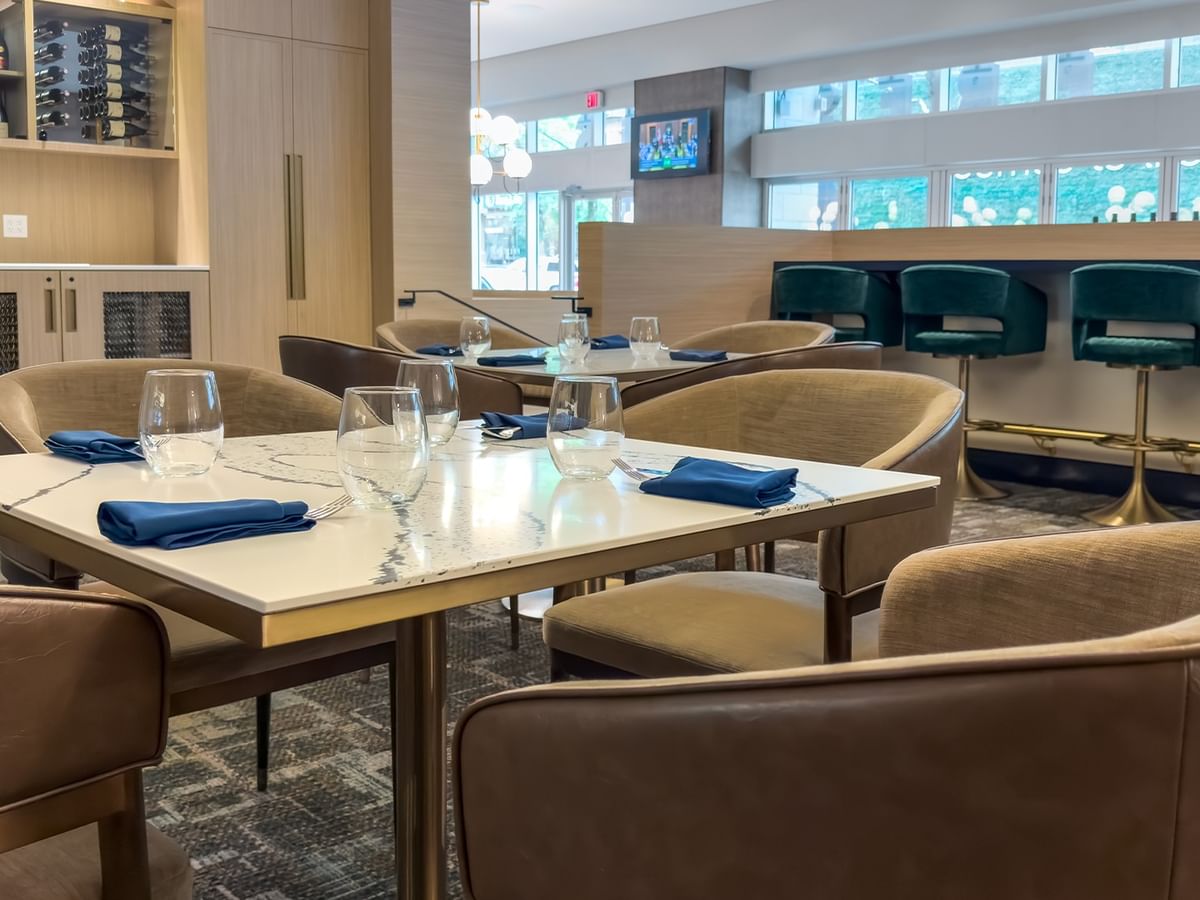 Dining area with chairs and set tables.