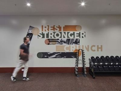 Man walks past gym wall with 