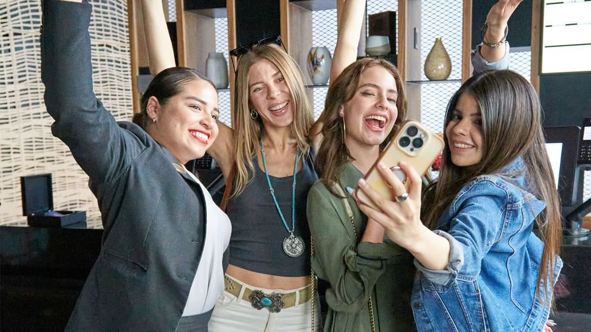 Four women smiling and posing for a selfie at Fiesta Americana