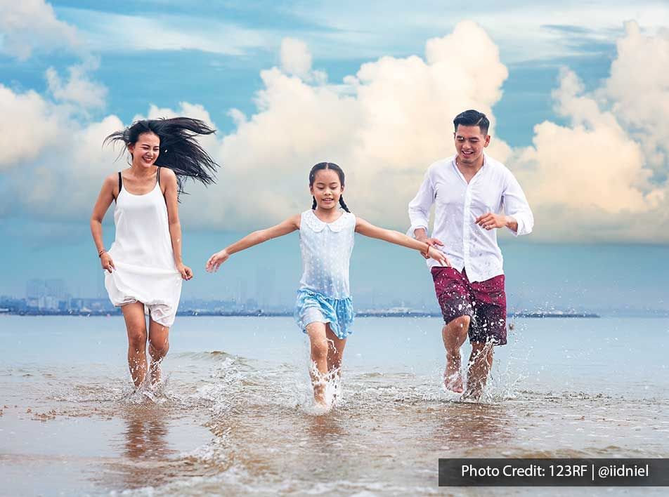 family playing on the beach shore