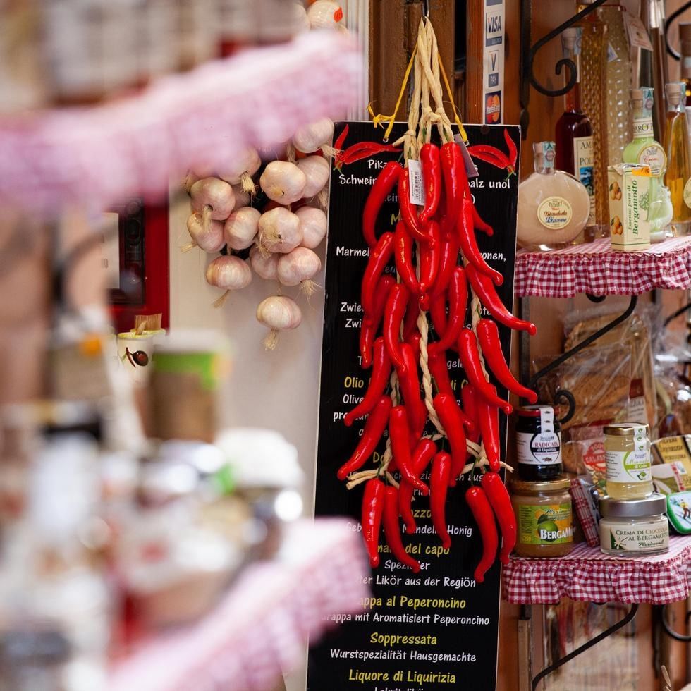 Red peppers and garlic hanging from a menu at Benvenuti al Fud.