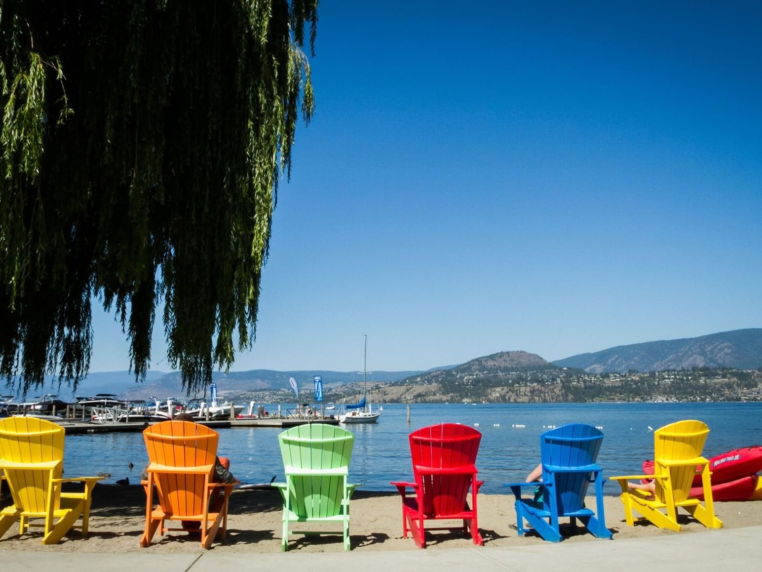 Colorful chairs facing the beach near Manteo Resort