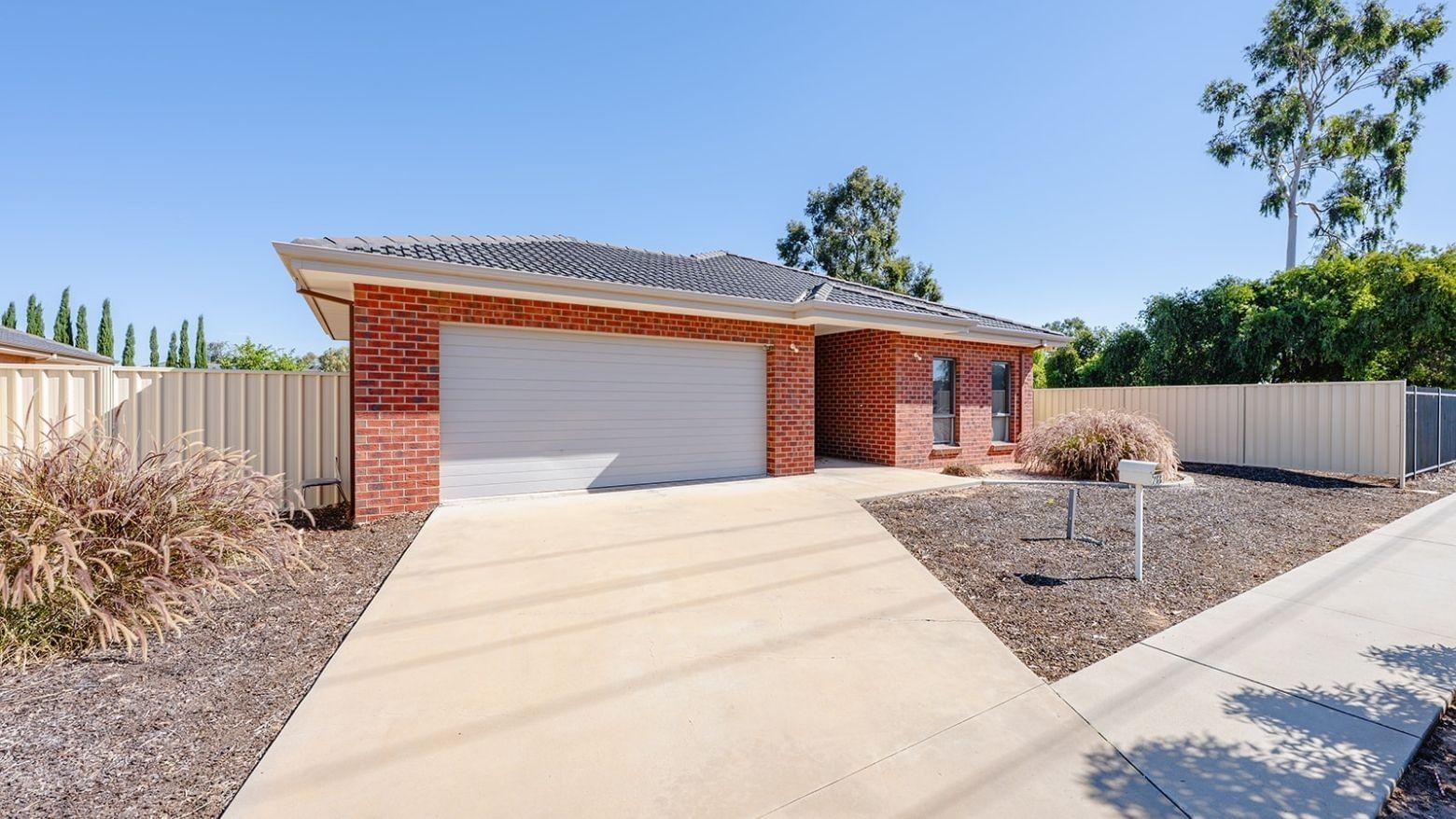 La Trobe University Regional Housing in Mildura with a driveway and fenced garden.