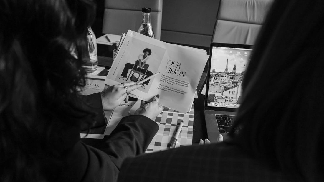 Black & white image of lady discussing a proposal in Niche Conference Room at Pullman Sydney Olympic Park