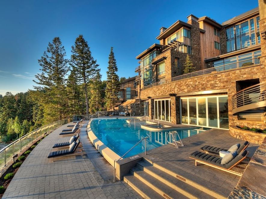 Outdoor infinity pool at dawn with surroundings in Stein Eriksen Residences