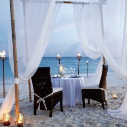 Romantic dinner table on the beach at The Somerset On Grace Bay