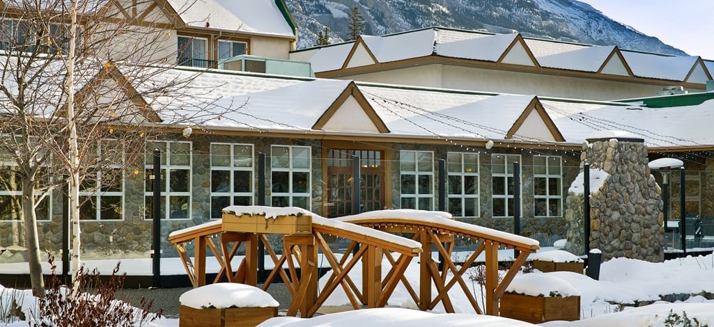 Coast Canmore Hotel's scenic architecture surrounded by a winter wonderland in the Rockies.