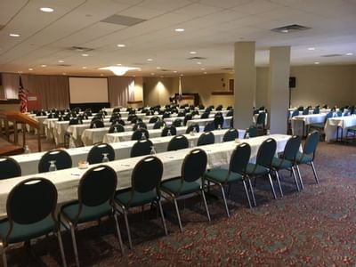 Tables setup for an event in meeting hall at UMass Lowell Inn