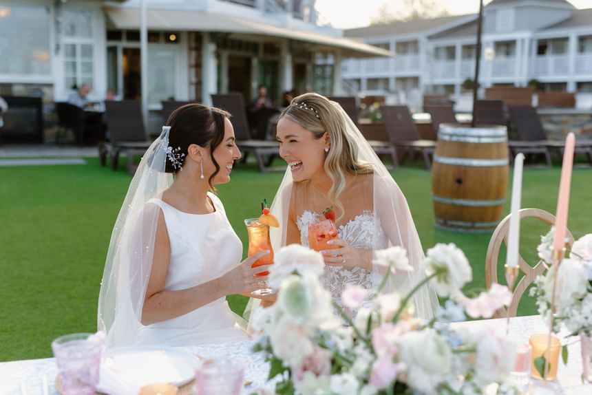 Brides enjoying cocktails in the outdoor event held at Ogunquit Collection