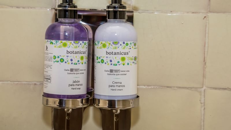 Close-up of hand soap & hand cream dispensers in a bathroom at Gamma Puebla Senorial Centro