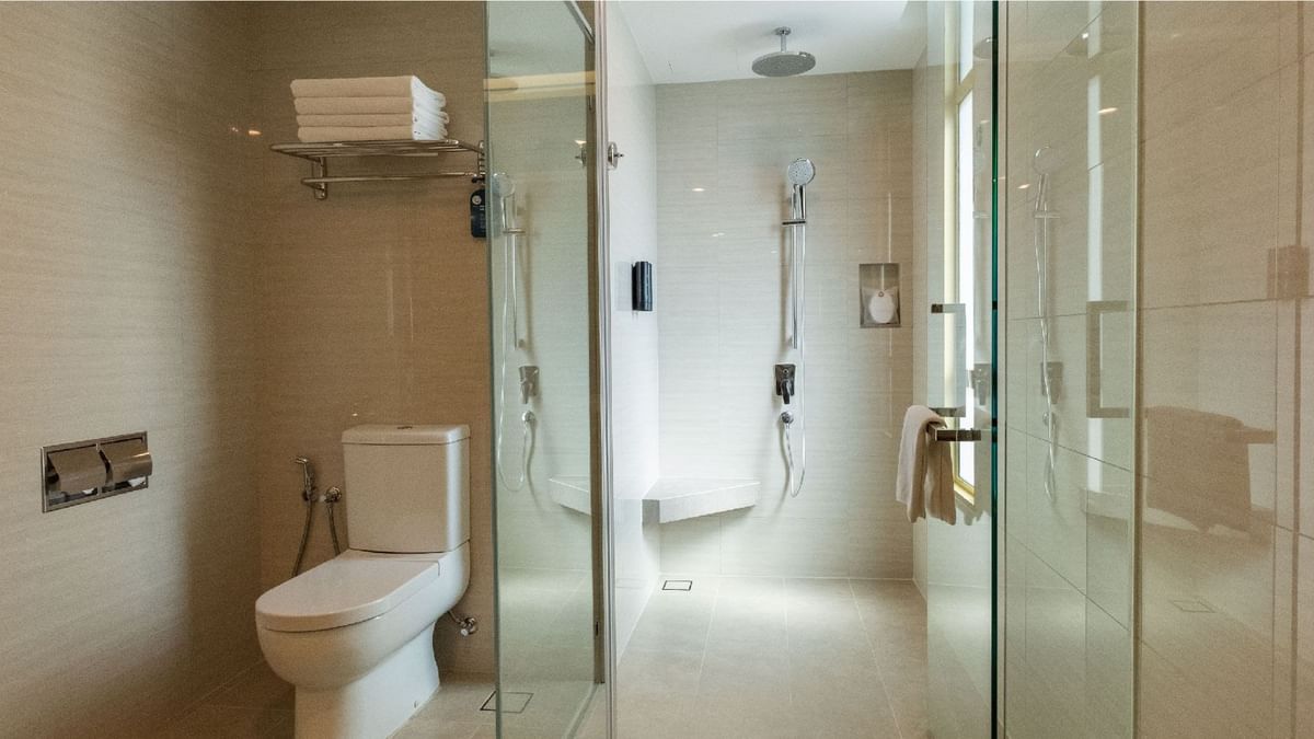 Clean, modern family room bathroom with a spacious walk-in shower and toilet at Sunway Lagoon Hotel