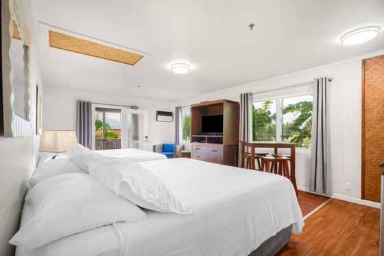 Two comfy beds & wooden furniture in Studio Suite View at Paradise Bay Resort