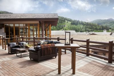 Couches & tables in a ballroom terrace at Stein Eriksen Lodge